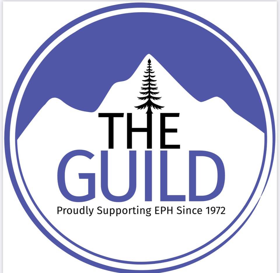 Circular logo for The Guild, featuring a mountain outline with a tree at the peak. The text reads "THE GUILD" and "Proudly Supporting EPH Since 1972.