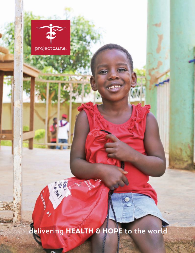 A smiling child holds a red bag with a medical logo and sits on a porch, with the text 