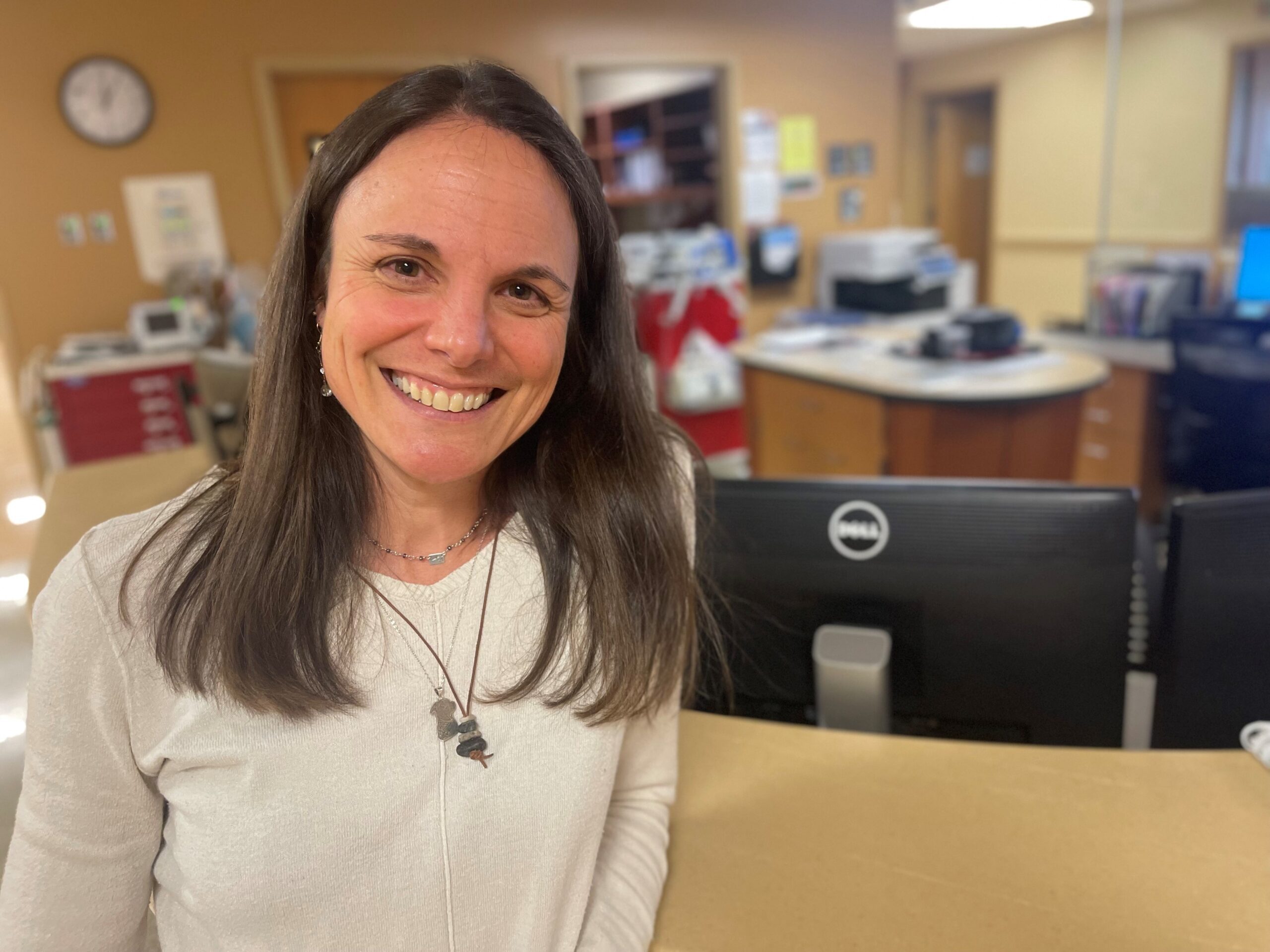 A woman smiling at camera.