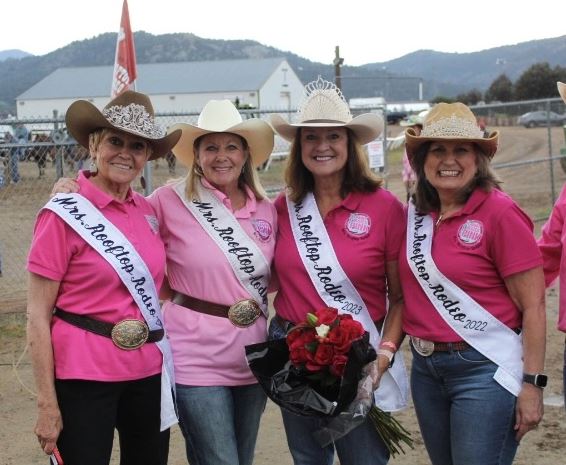 Four women wearing cowgirl hats and sashes with 