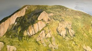 A lush green hill with rocky outcrops is shown under a partially cloudy sky in a detailed painting.