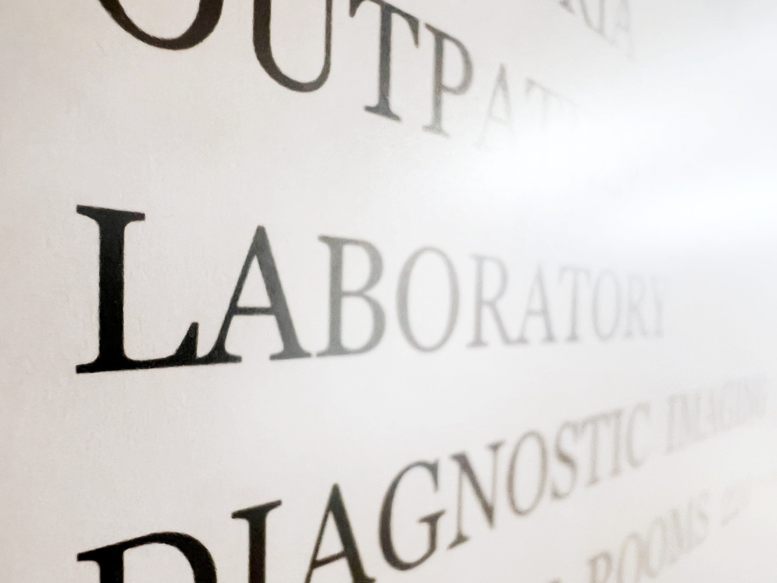 Close-up of a wall with large black text including the words